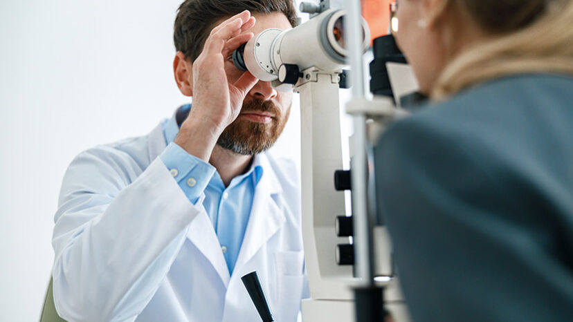 Optometrist checks the patient’s intraocular pressure in optician’s shop or ophthalmology clinic