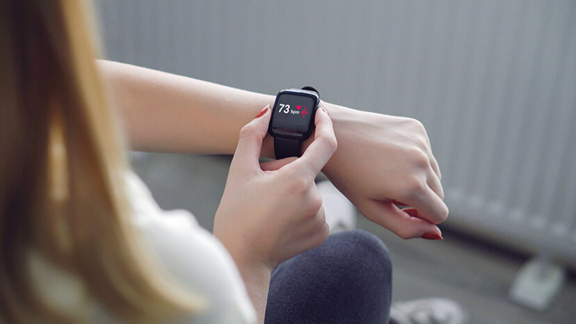 calculating heart rate. Young beautiful girl says check the incoming health data. Check ECG by smart watch