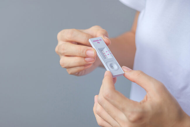 man holding Rapid Antigen Test kit with Negative result during swab COVID-19 testing. Coronavirus Self nasal or Home test, Lockdown and Home Isolation concept